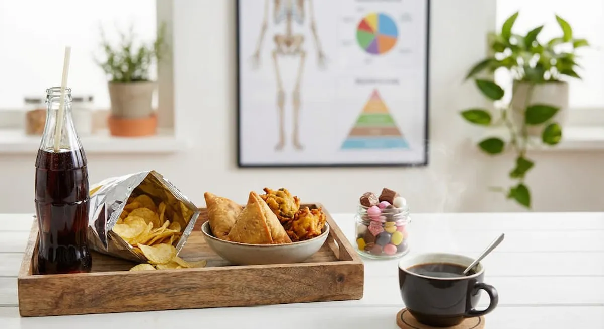 Unhealthy sugary and fried snacks shown as foods to avoid with broken bones due to poor calcium absorption and inflammation