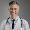 Smiling male doctor in white coat and stethoscope offering professional healthcare services