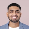 Young male patient smiling and sharing a positive review for healthcare services